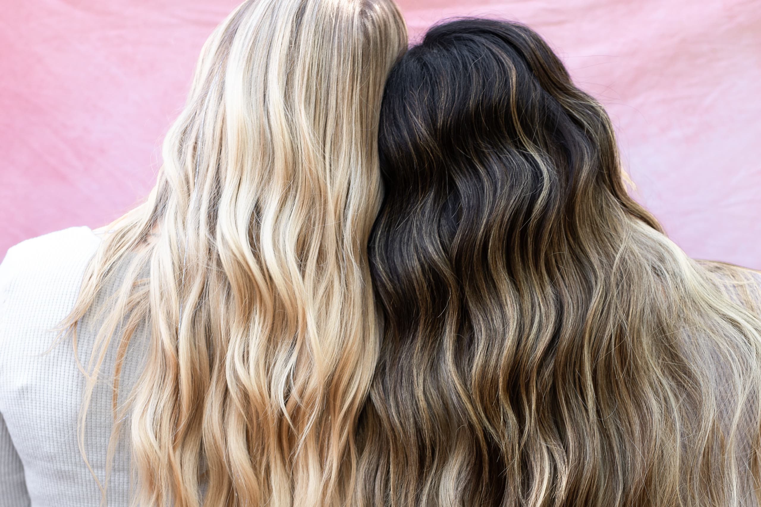 Two Bloom Salon ATX clients showing off finished hand tied extension transformations